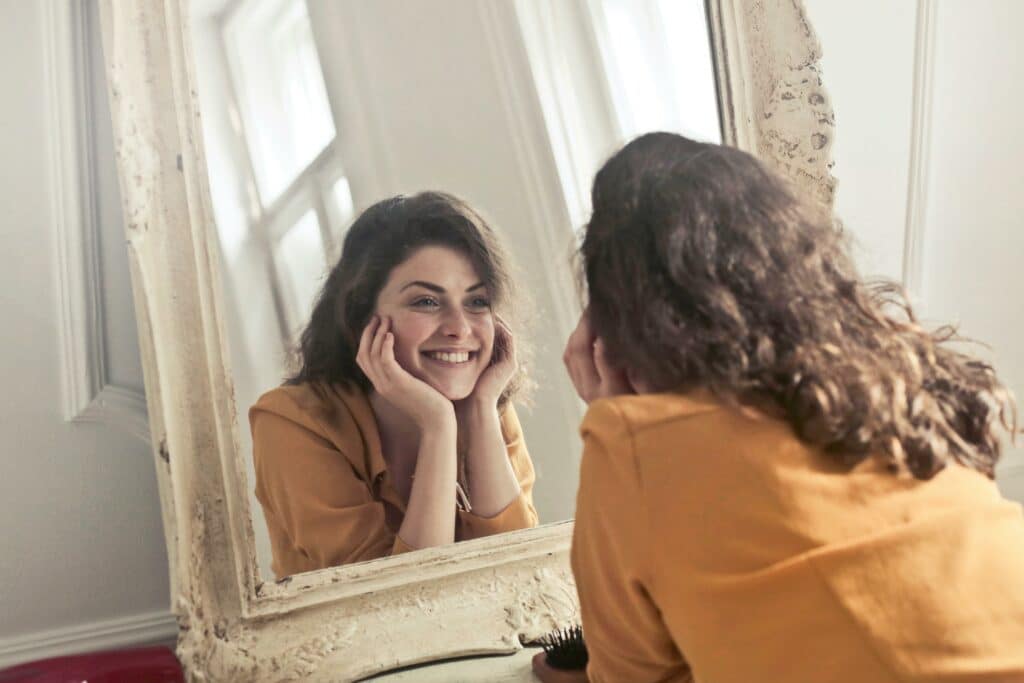 woman smiling in her reflection